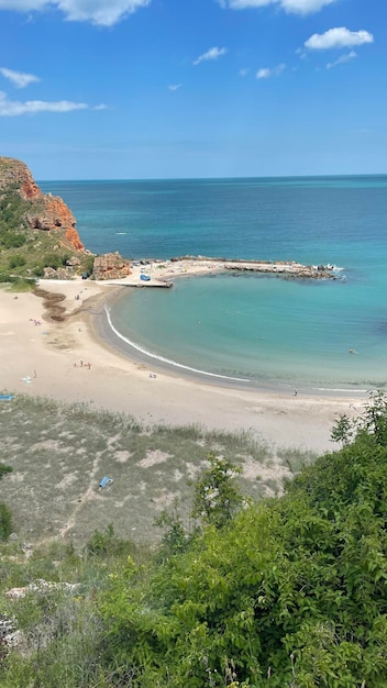 A beach with a blue sky and a white sandy beach