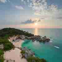 Photo a beach with a boat in the water and a sunset in the sky