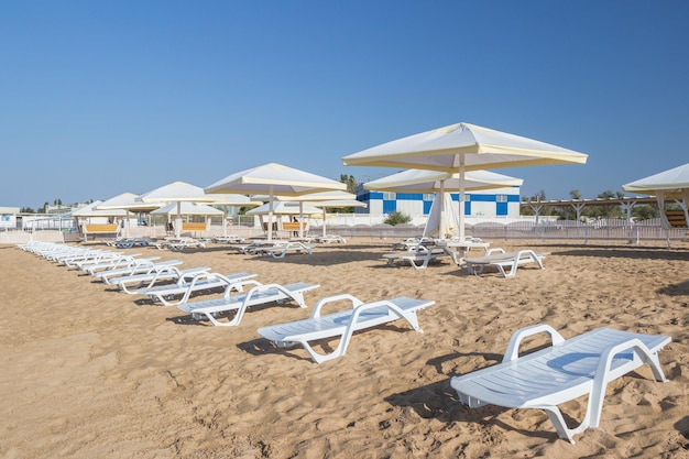 Beach with chairs and thatched umbrellas