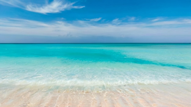 a beach with a clear blue water and a sky with clouds