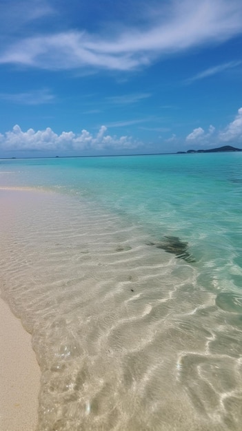 Photo a beach with clear water and a blue sky