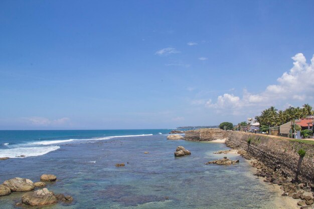 A beach with a house on the left and a house on the right.