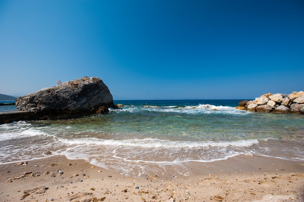 Beach with stones at the shore and large near the river