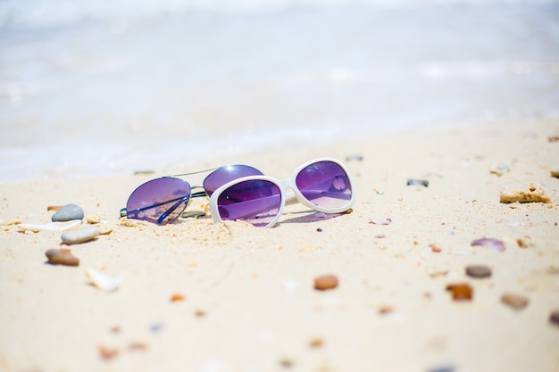 The beach with sunglasses on the rock