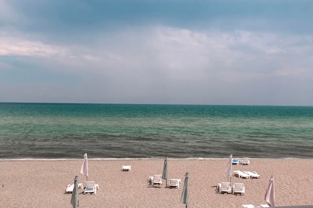 A beach with umbrellas and chairs