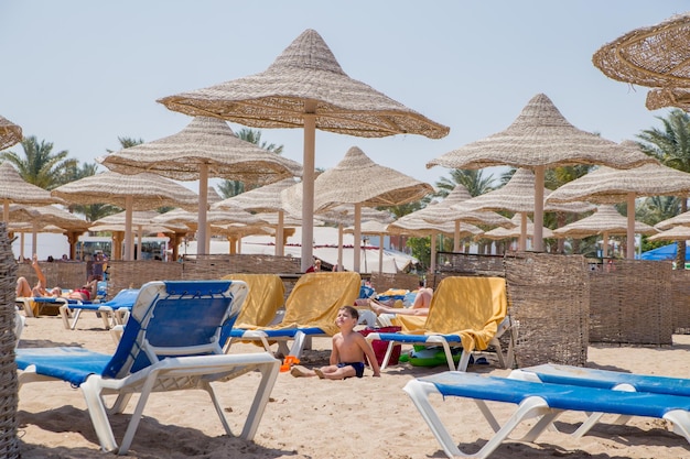 Beach with umbrellas and sun loungers by the sea