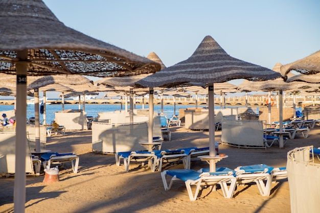 Beach with umbrellas and sun loungers by the sea