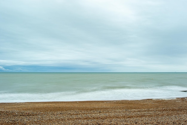 A beach with a view of the sea and the horizon