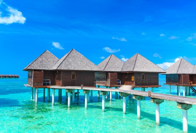 beach with water bungalows Maldives