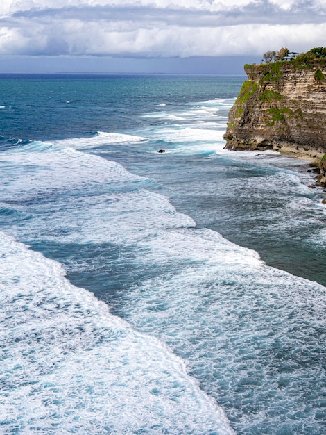 A beach with waves crashing on the shore