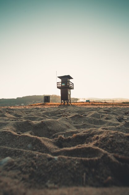 Beachguard tower during sunrise from the sand