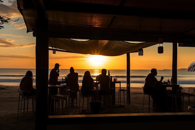 Фото Пляжная закусочная с видом на закат над океаном и силуэты людей на песке