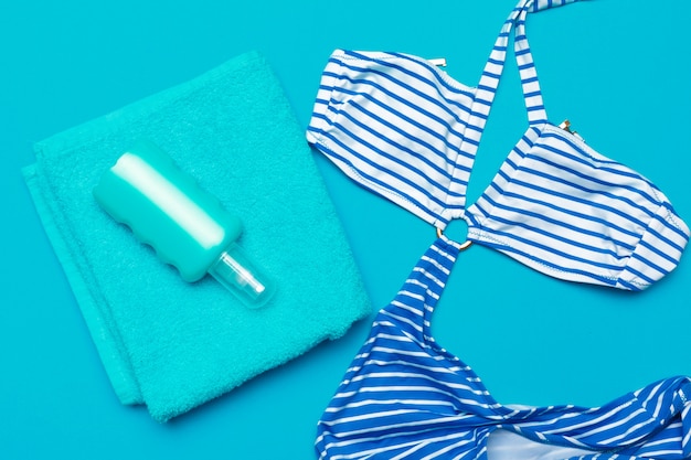 Beachwear and accessories on a blue