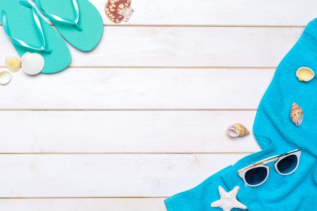 Beachwear and accessories on a white wooden