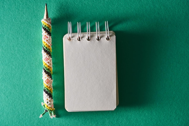 Beaded pen or pencil holder from sarawak with blank note pad for copy space