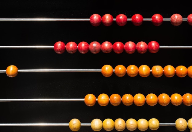 Beads on wooden rainbow abacus for number calculation Mathematics learning concept