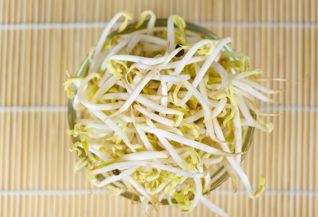 Photo bean sprouts cup on wooden , top view