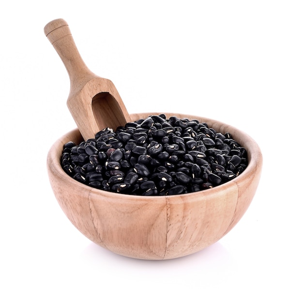 Beans black in wooden bowl on white background