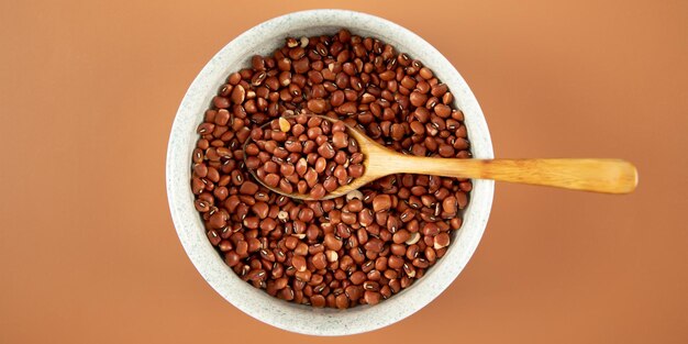 Beans in a bowl and wooden spoon