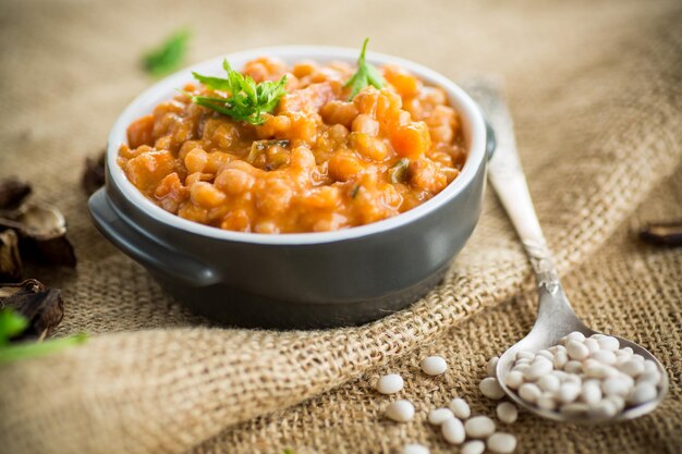 beans stewed with vegetables and spices in a bowl