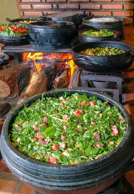 Beans with pork called tropeiro beans typical brazilian food\
state of minas gerais beans tropeiro in the wood stovexdxd