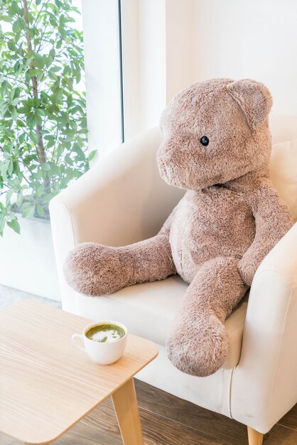 bear doll sit on sofa 