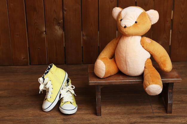 Bear toy on bench on wooden surface