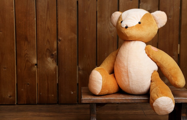 Bear toy on bench on wooden table