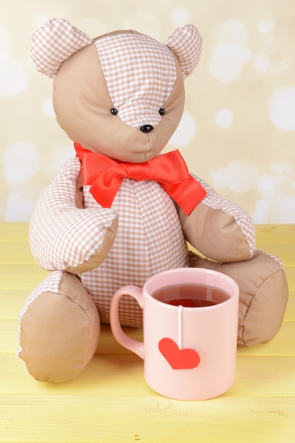 Bear toy on table on light background