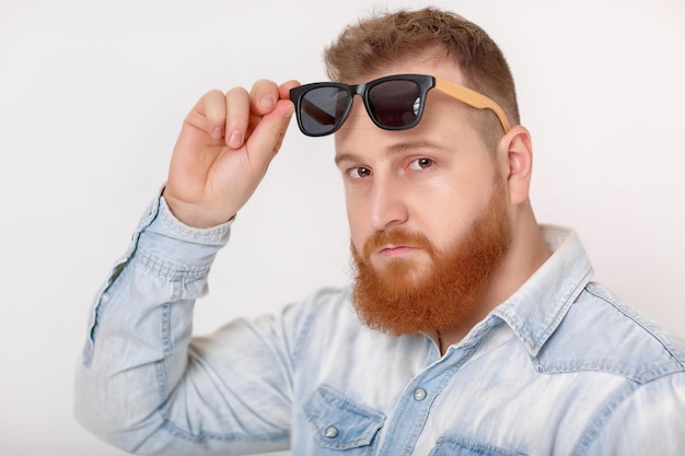 Beard man in sunglasses and denim shirt