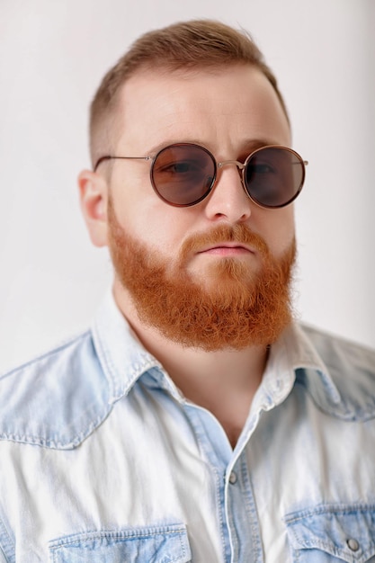 Beard man in sunglasses and denim shirt