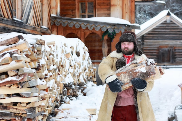 Beard man in traditional winter costume of peasant medieval age in russia