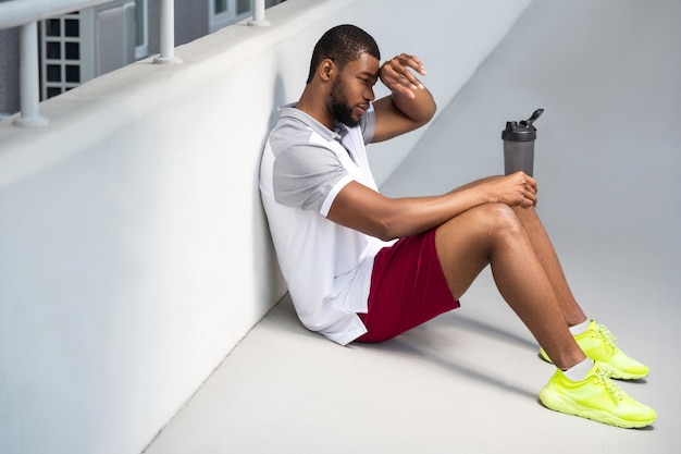 Bearded athletic man relaxing after the morning workout