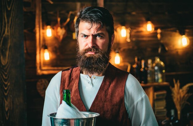 Bearded bartender or waiter in work uniform long bearded waiter or servant brutal bearded servant