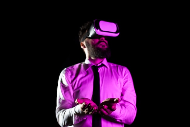 Bearded Businessman Wearing Virtual Reality Goggles And Enjoying Simulator Light Falling On Man Using Futuristic Gadget Gesturing And Presenting Modern Innovative Technology