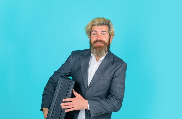 Bearded businessman with case selfconfident businessman in black suit and white shirt with black