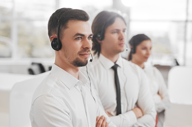 Bearded call center agent with team