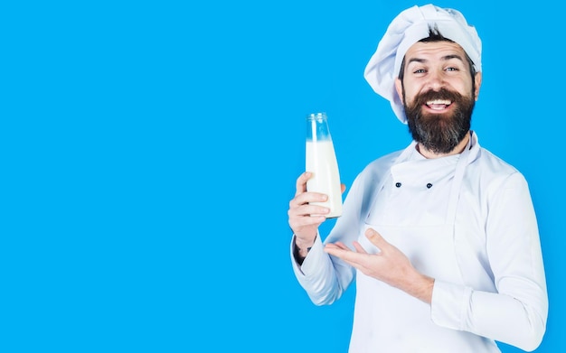 Bearded chef presenting bottle milk or milkshake dairy products protein diet lactose free yoghurt