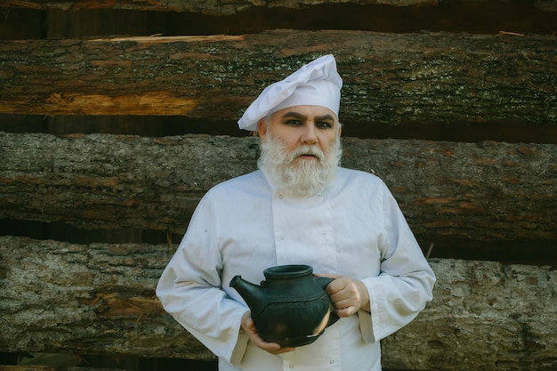 Bearded cook with iron tea kettle