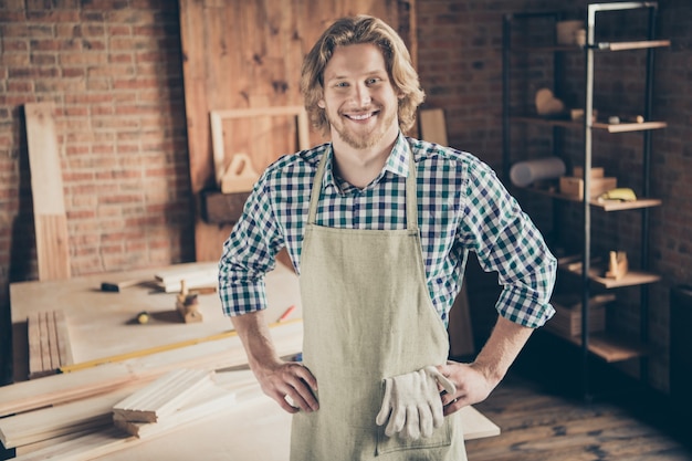 bearded craftsman posing in his woodshop