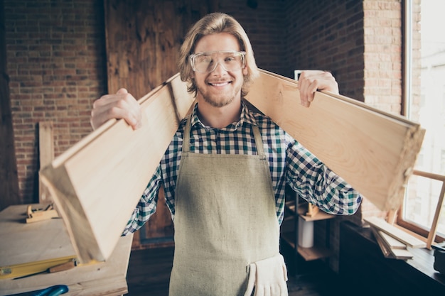 bearded craftsman posing in his woodshop