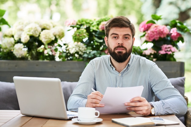 Bearded Entrepreneur Working in Outdoor Cafe