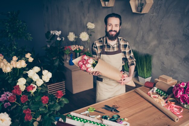 bearded florist working in his flower shop