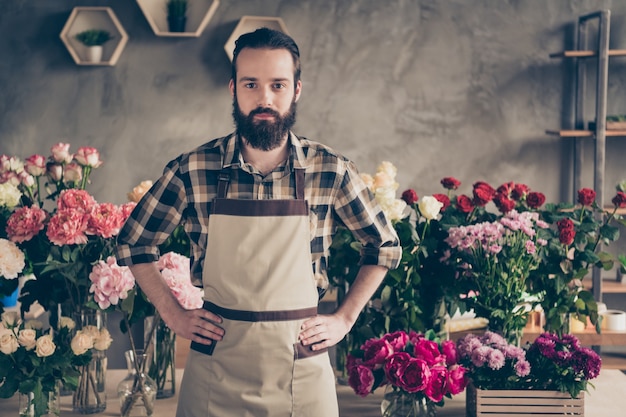 bearded florist working in his flower shop