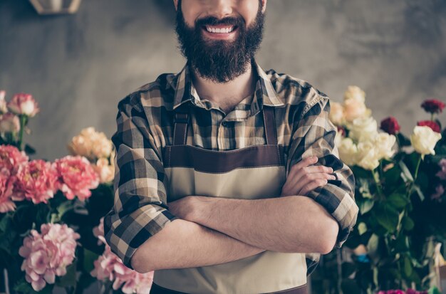 bearded florist working in his flower shop