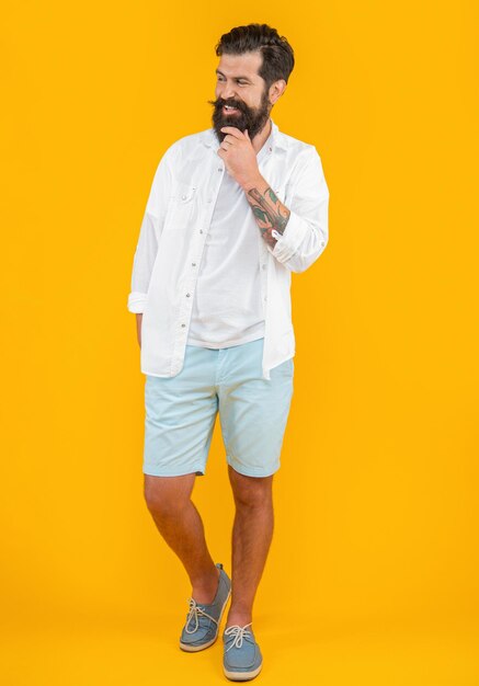 bearded guy on background photo of bearded guy wearing summer fashion bearded guy isolated on yellow bearded guy in studio