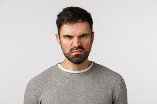 Photo bearded guy in grey sweater with angry face