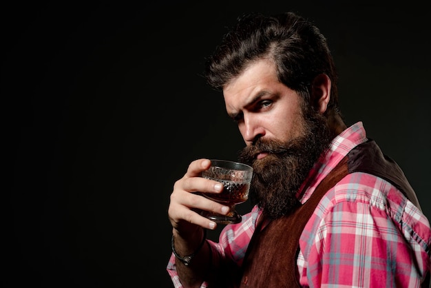 Bearded handsome man holding glass of whiskey Sipping finest whiskey Fashion style concept Businessm