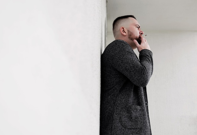 Bearded hipster man smoking cigarette