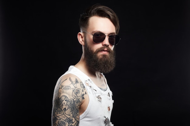 bearded hipster in vintage torn dirty shirt